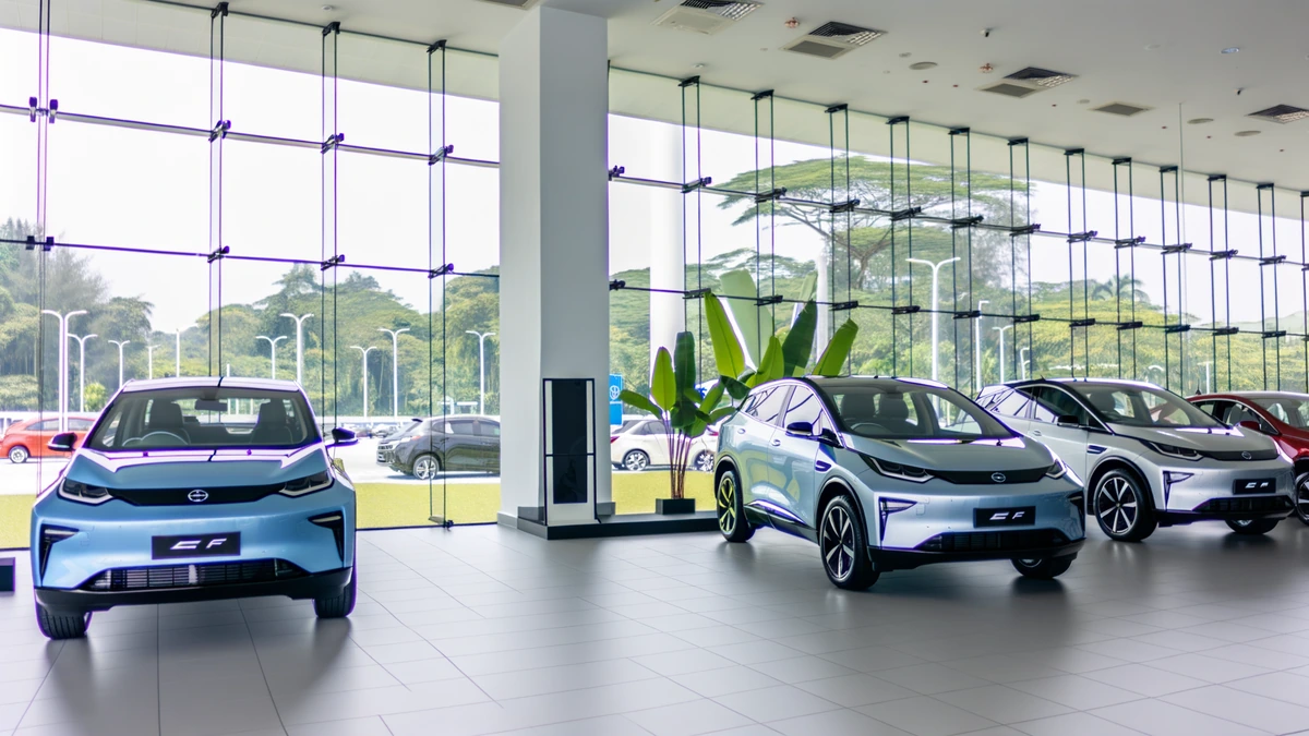 BYD Atto 3 vs Proton eMas 7 electric SUV comparison in modern showroom