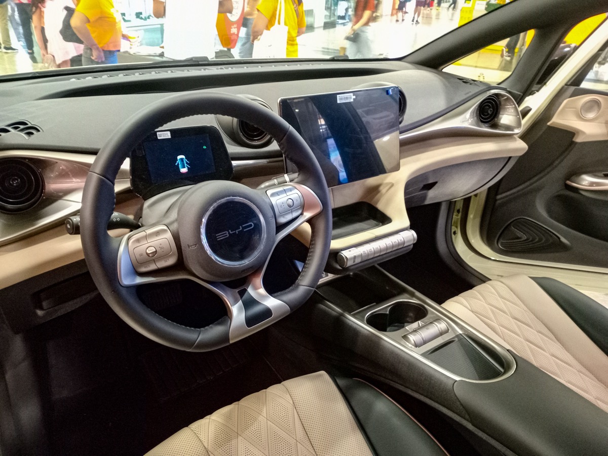 BYD Dolphin interior dashboard showing 12.8-inch rotating infotainment screen