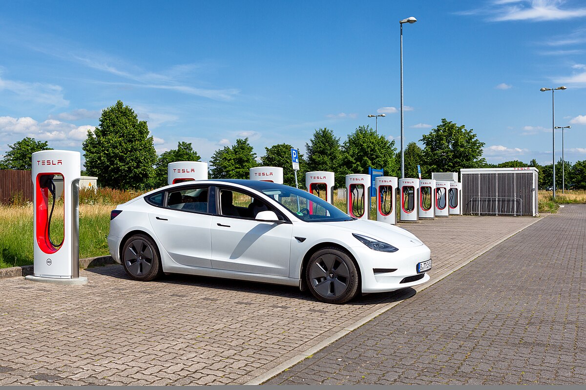 Tesla Supercharger station with multiple charging stalls for electric vehicles