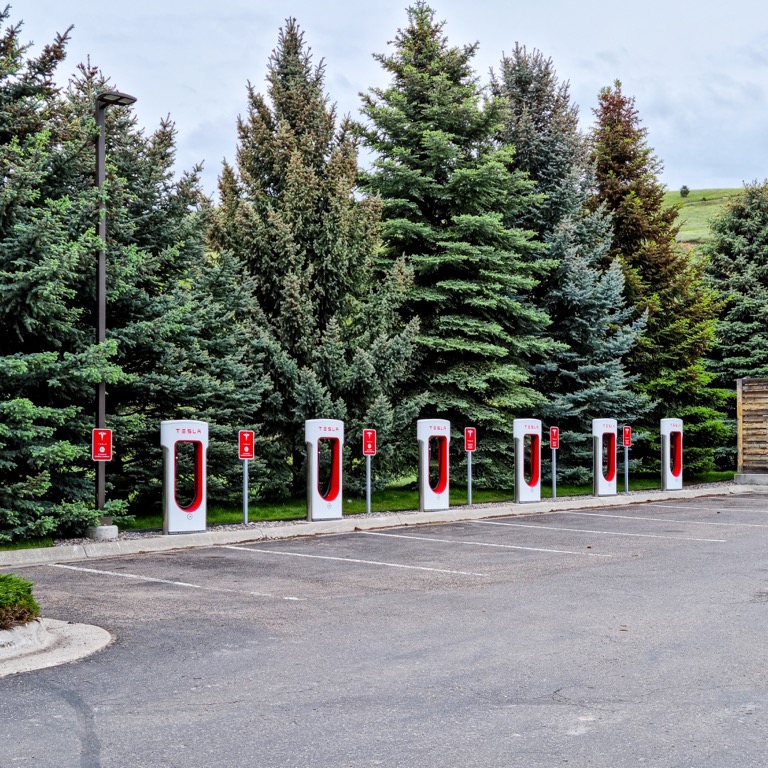 Tesla Supercharger station with multiple charging stalls for electric vehicles