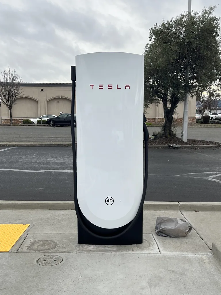 Tesla V4 Supercharger stall with CCS2 connector close-up view