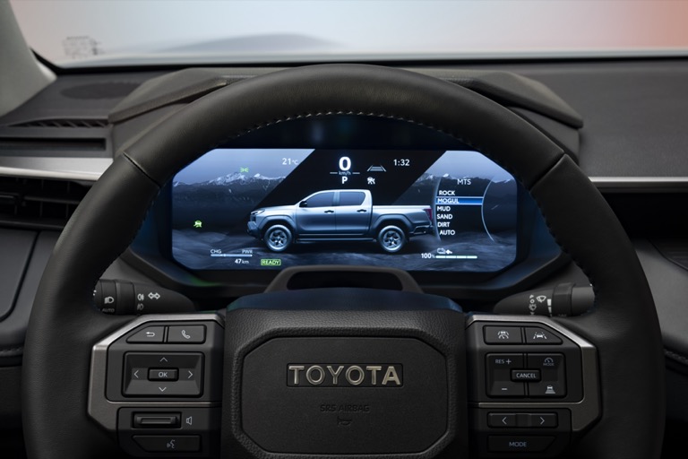 Toyota Hilux BEV 12.3-inch digital instrument cluster showing battery and drive modes