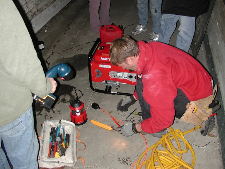 Licensed electrician performing EV charger installation work on residential electrical panel Malaysia